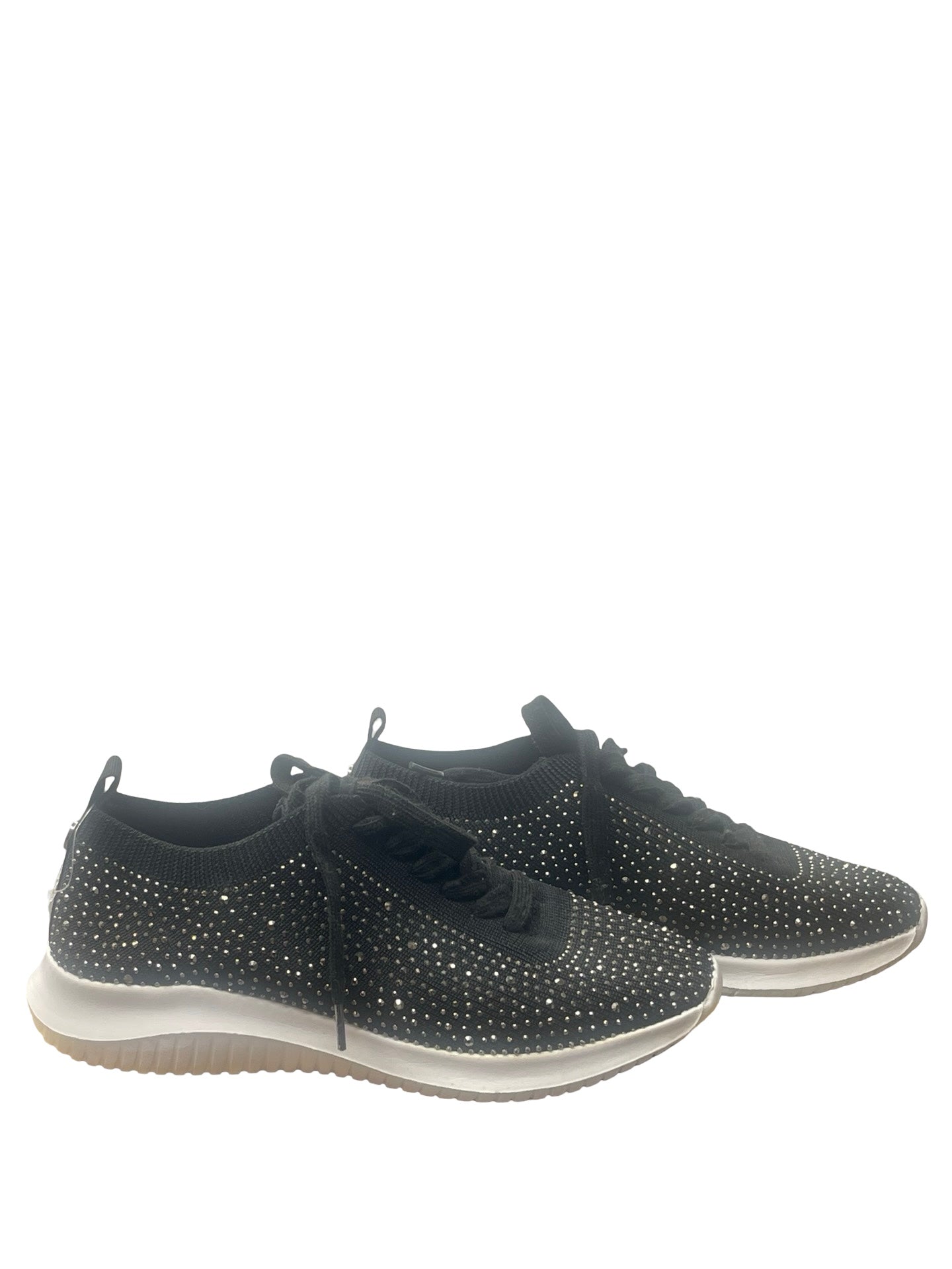 A pair of black knit low-top sneakers covered in silver rhinestones, featuring black laces and a white midsole with a gum outsole, shown against a plain white background.