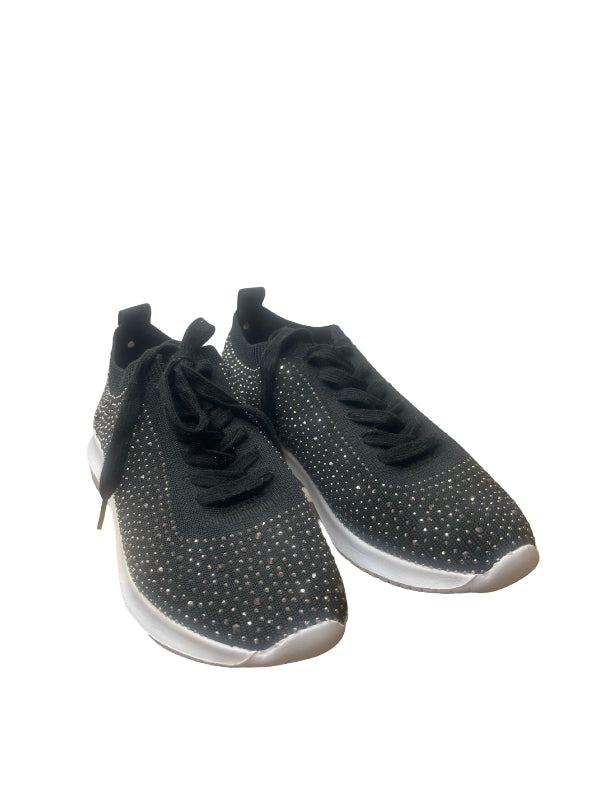 A pair of black knit sneakers embellished with silver rhinestones, featuring black laces and white soles, set against a plain white background.