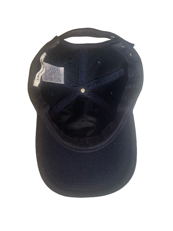 A dark navy blue baseball cap shown from the back, featuring a structured crown, curved brim, and an adjustable back strap with a white paper tag attached.