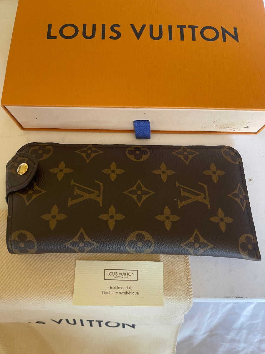 A Louis Vuitton monogram wallet in dark brown coated canvas with tan LV logos, shown next to its orange box and dust bag.