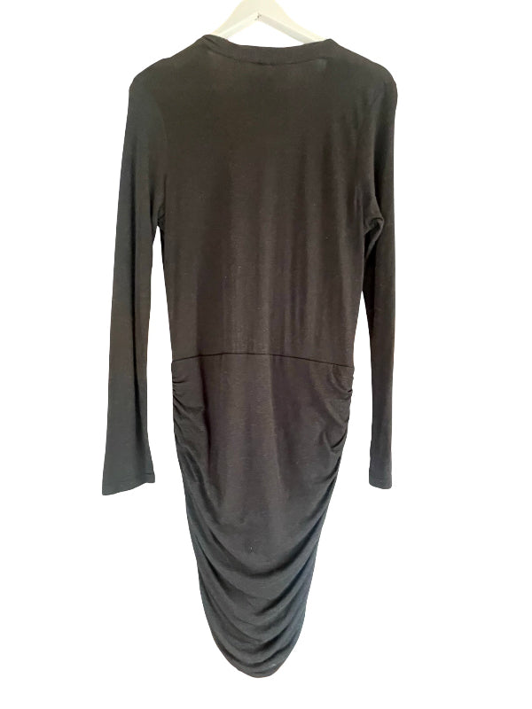 A black long-sleeve body con dress with a gathered ruched skirt, hanging on a white hanger against a white background.