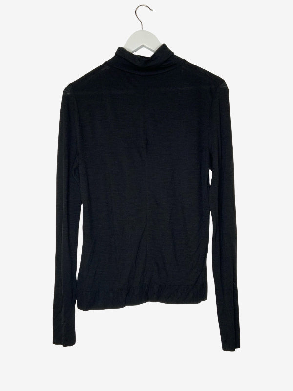 A black long-sleeve turtleneck top hanging on a white hanger against a plain white background.