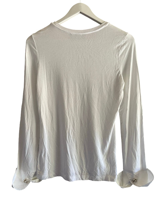 A white long-sleeve blouse with rolled cuffs and small decorative buttons, hanging on a white hanger against a white background.