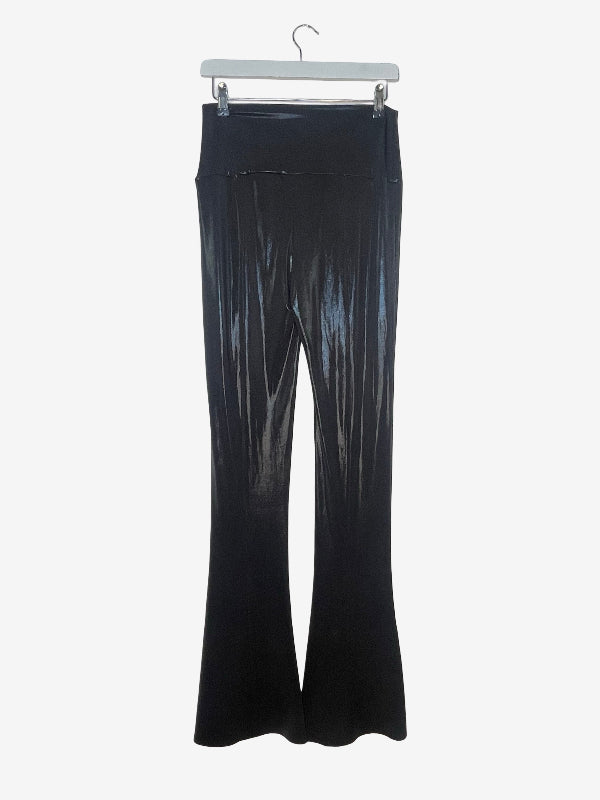 Black flared pants with a shiny, pleated texture, hanging from a white hanger against a light gray background.