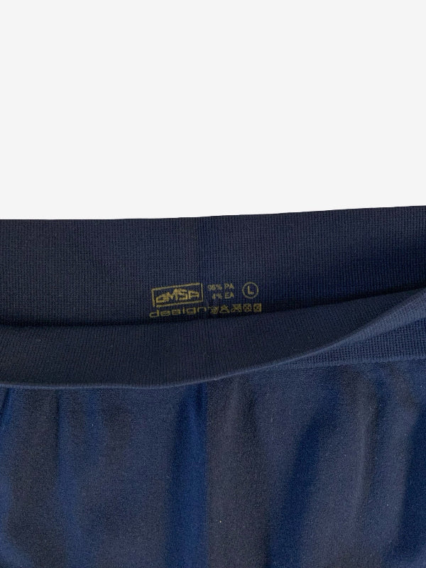 Close-up of the waistband of dark navy blue shorts, showing the inner label with 'OSMA’ and size L information