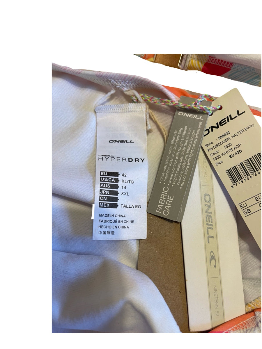 Close-up of a garment tag and care label on a light-colored item, showing O'Neill branding and HyperDry technology text.