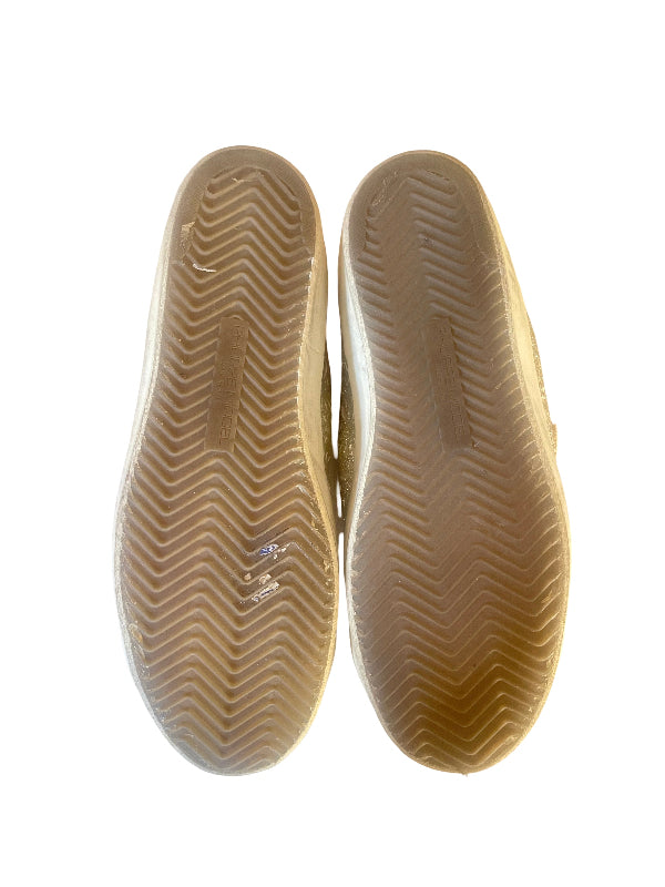 A pair of beige rubber shoe soles shown from the bottom against a plain white background.