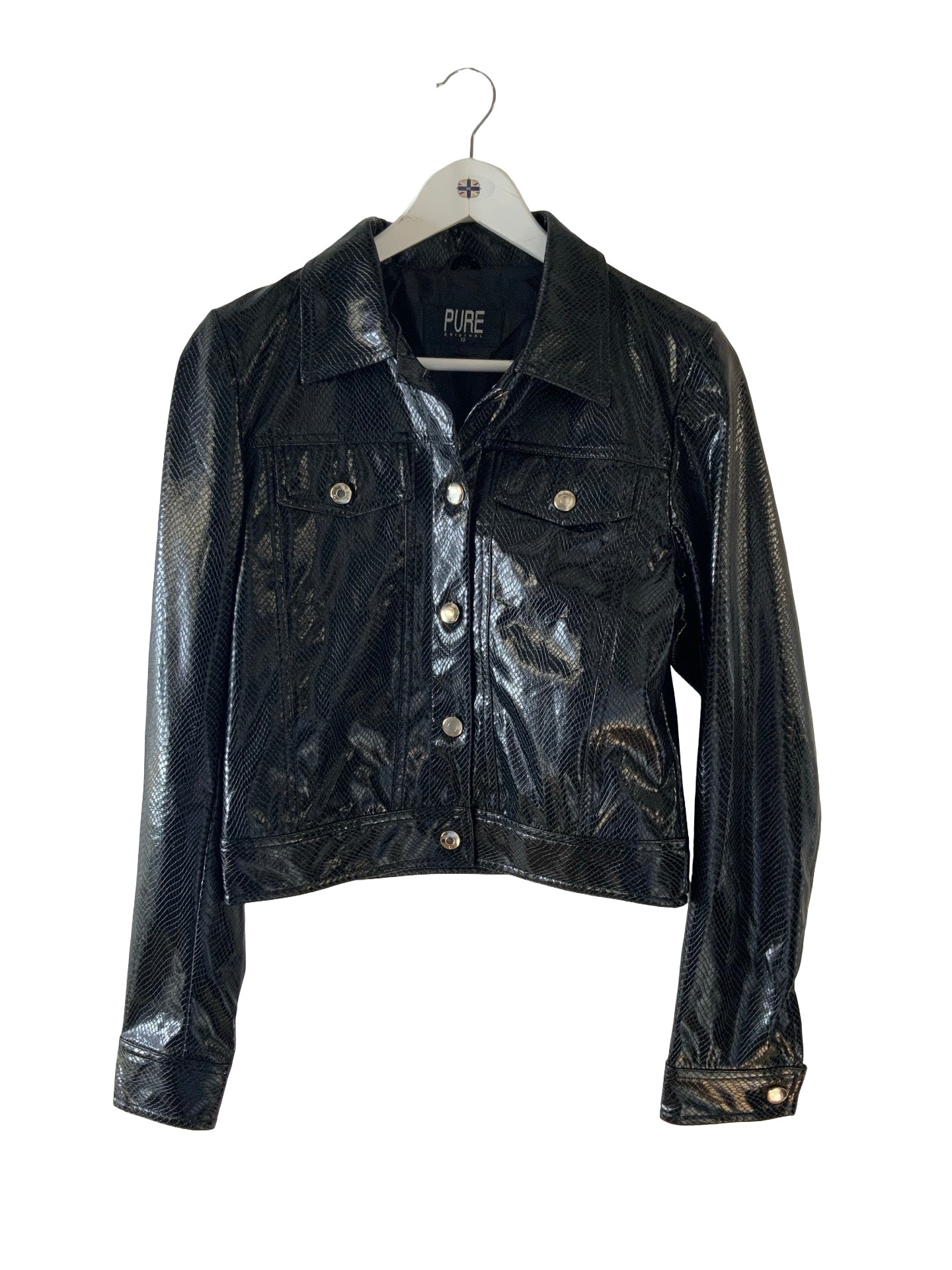 A black textured faux-leather jacket with a collar, button front, and flap chest pockets, hanging on a white hanger against a plain white background.