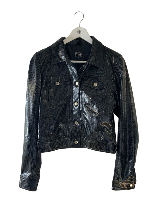 A black textured faux-leather jacket with a collar, button front, and flap chest pockets, hanging on a white hanger against a plain white background.