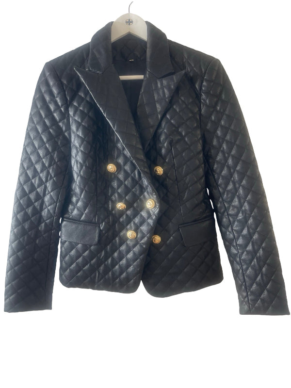 A black quilted faux leather double-breasted blazer jacket with gold buttons, hanging on a white hanger against a white background.