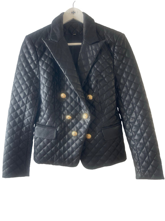 A black quilted faux leather double-breasted blazer jacket with gold buttons, hanging on a white hanger against a white background.
