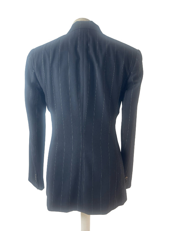 A black pinstripe blazer shown from the back on a mannequin torso against a white background.