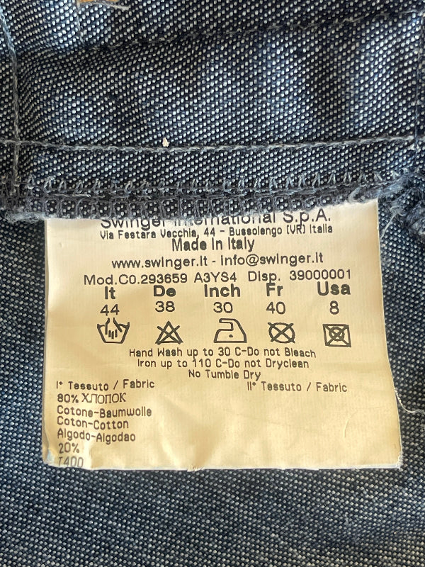 A close-up of a sewn fabric label reading 'Swinger International S.P.A