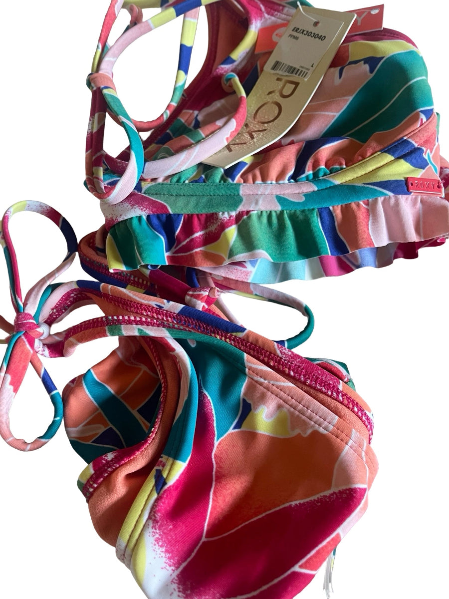 A two-piece bikini set with a vibrant, multicolor abstract floral print, featuring a ruffled underbust band on the top and side-tie straps on the bottoms. The swimsuit is shown with its original paper tag attached, set against a plain white background.