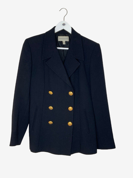 A black double-breasted blazer with gold buttons, hanging on a white hanger against a light gray background.