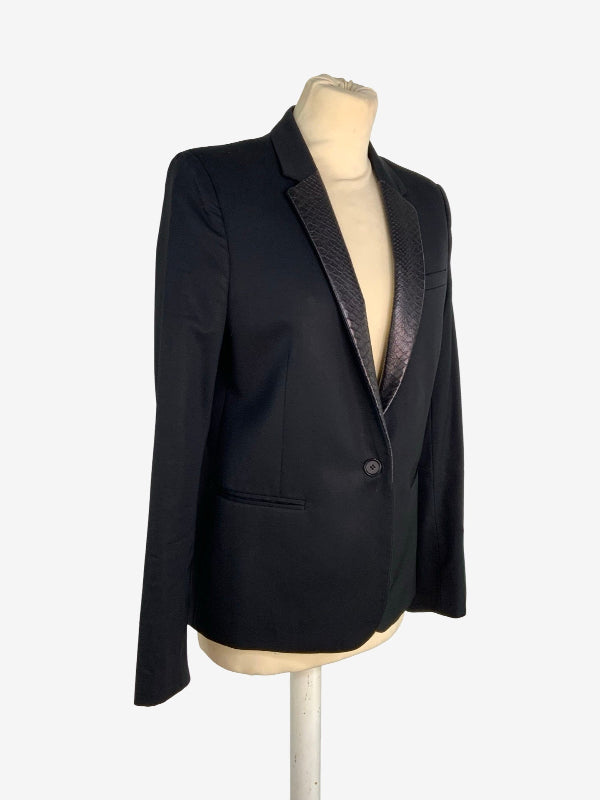 A black women's blazer with contrasting textured leather  lapels, displayed on a beige mannequin torso against a light gray background.