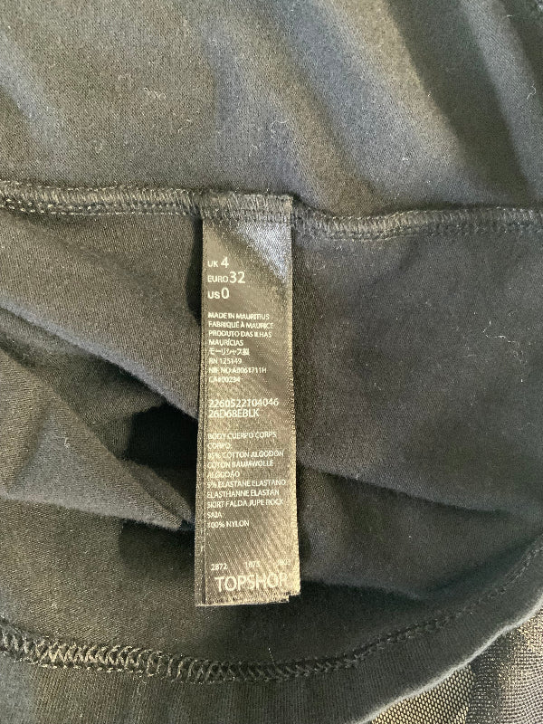 Close-up of a dark gray garment's interior neck label, showing size information and the brand name TOPSHOP.