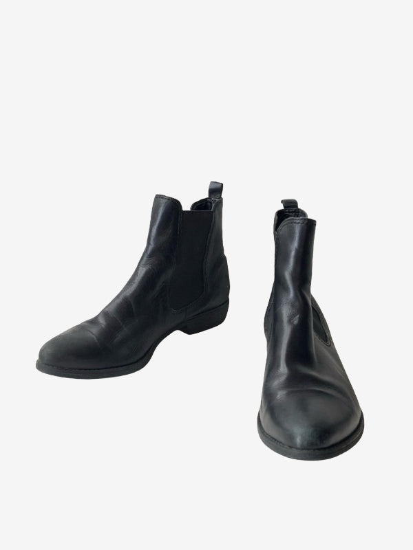 A pair of black leather Chelsea boots shown from the side and front angles against a plain white background.