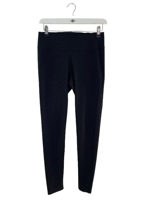 Black full-length leggings hanging from a white hanger against a plain white background.