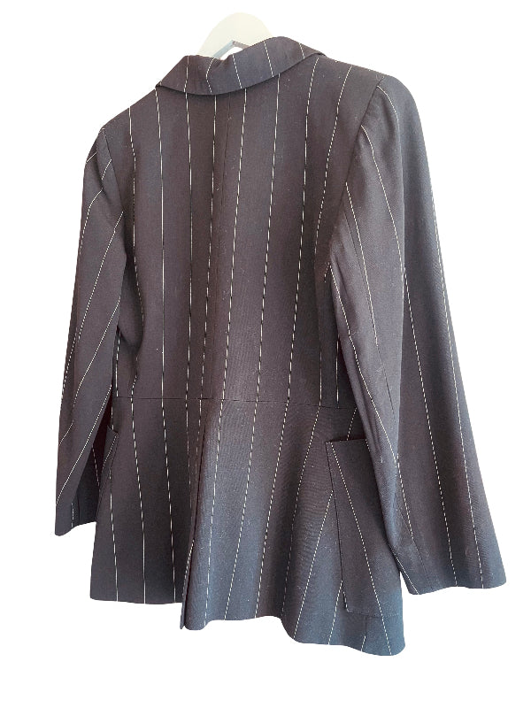 A black pinstripe blazer jacket with long sleeves and a notched collar, hanging on a white hanger against a plain white background.