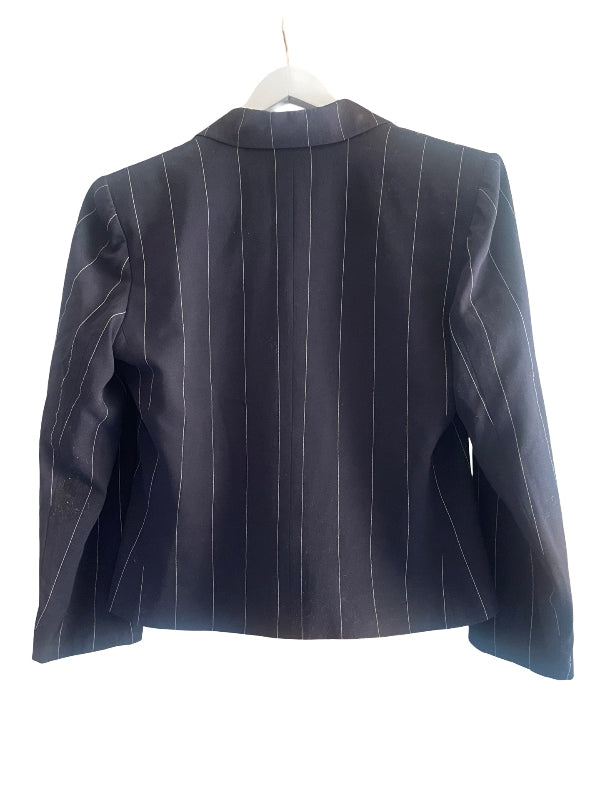 A dark navy blue pinstripe blazer jacket with long sleeves, shown from the back on a white hanger against a white background.