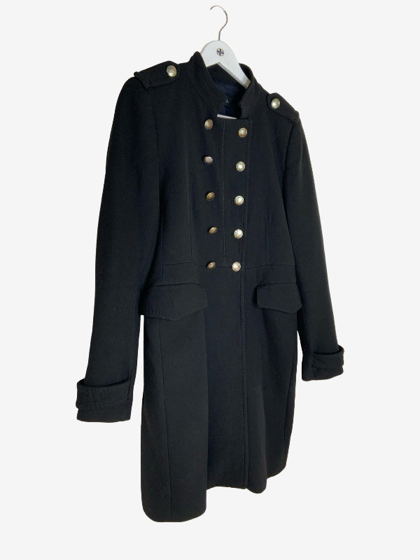 A black double-breasted military-style coat with silver buttons, hanging on a white hanger against a light gray background.