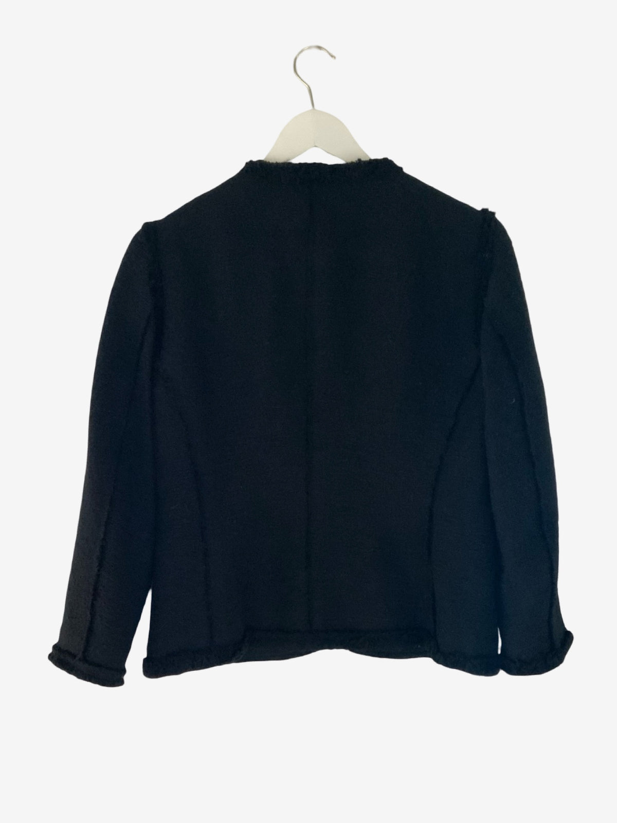 A black long-sleeve cropped jacket with a high ruffled collar, hanging on a white hanger against a plain white background.
