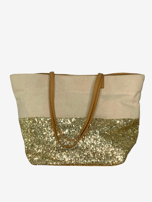 A tote bag with a natural canvas upper half, a gold glitter lower half, and tan shoulder straps, shown against a plain white background.