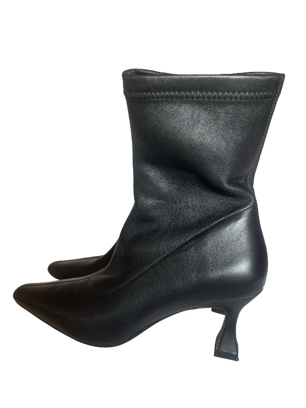 A single black leather ankle boot with a pointed toe and a short, sculptural kitten heel, shown from a side profile on a white background.