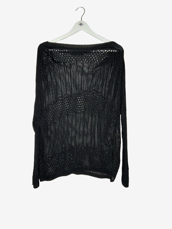 A black open-knit long-sleeve sweater hanging on a white wooden hanger against a light gray background.