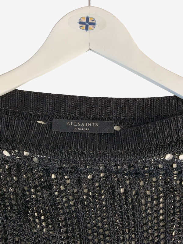Close-up of a black knit sweater hanging on a white hanger, showing the ribbed collar with a visible AllSaints label.