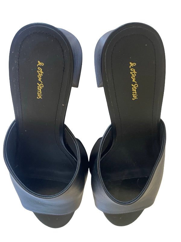 A pair of black leather slide sandals shown from a top-down view, displaying the black insoles with gold 'And other stories' branding.