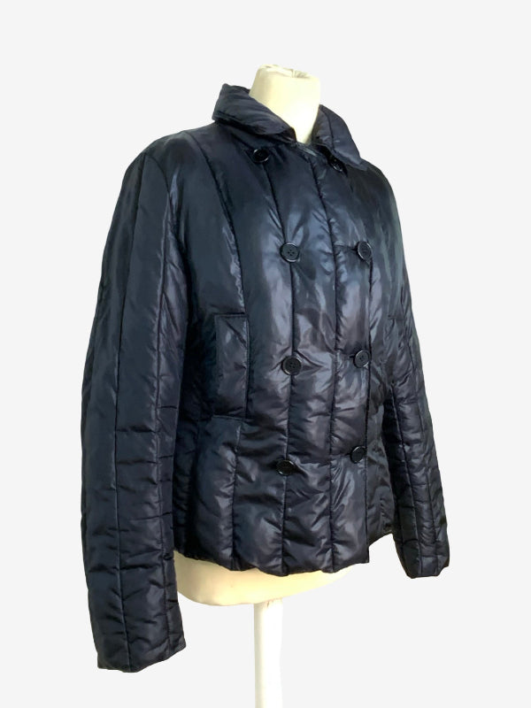 A black quilted puffer jacket displayed on a cream mannequin torso against a light gray background.