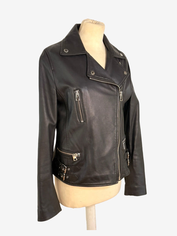 A black leather motorcycle jacket displayed on a beige mannequin torso against a light gray background.