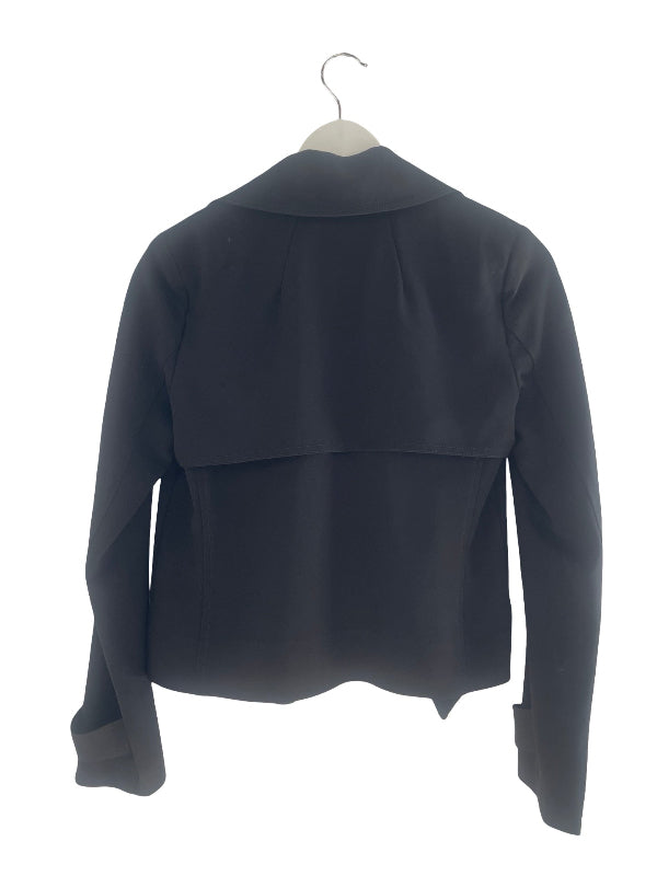 A black long-sleeve cropped jacket with a draped, layered back design, hanging on a white hanger against a plain white background.
