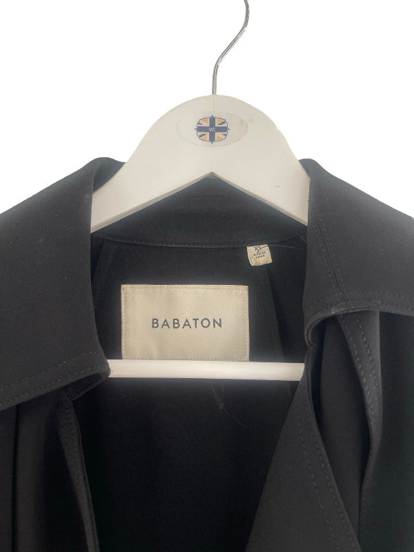 A black jacket hanging on a white hanger against a white background. The inner neck label reads BABATON.