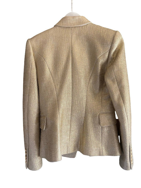 A textured champagne-gold blazer shown from the back, hanging on a white hanger against a plain white background.