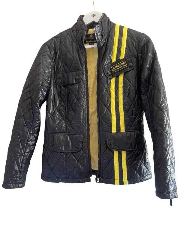 A black quilted leather jacket with two vertical yellow stripes on the front, featuring a zippered front, flap pockets, and a Barbour brand patch on the chest.