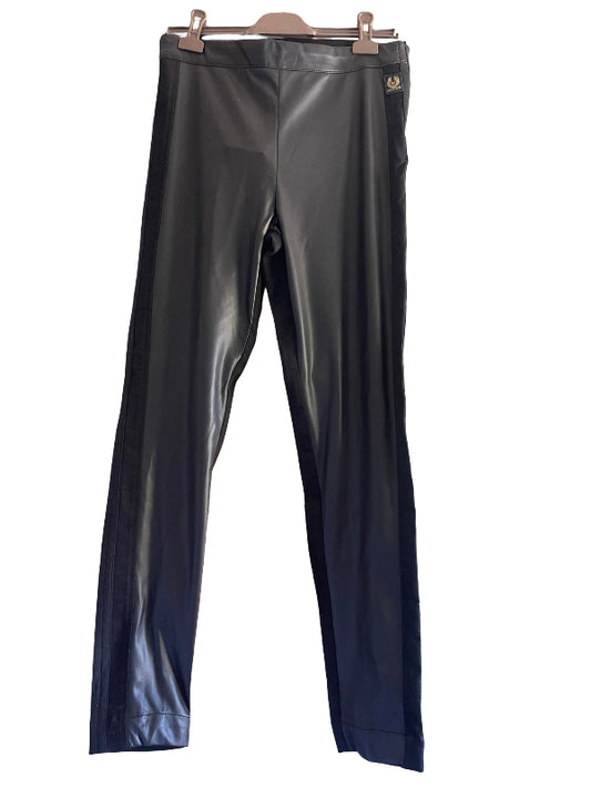 Black faux leather pants hanging on a wooden hanger against a white background.