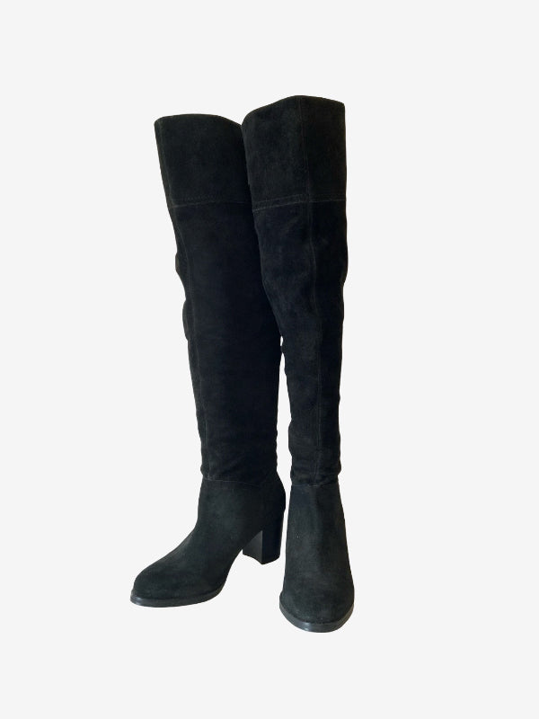 A pair of black suede over-the-knee boots with block heels, shown from a side profile against a plain white background.