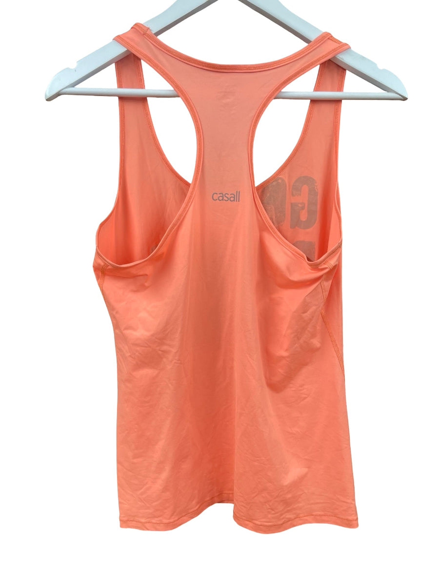 A coral orange racerback tank top hanging on a white plastic hanger against a white background. The brand name 'casali' is printed in black on the upper back, and a large tonal 'CG' logo is visible on the right side.