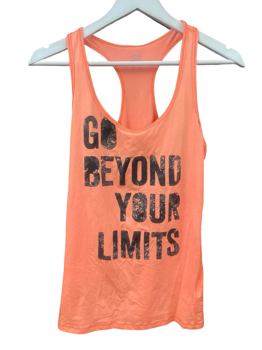 A coral pink racerback tank top with distressed black text reading 'GO BEYOND YOUR LIMITS' hanging on a white hanger against a white background.