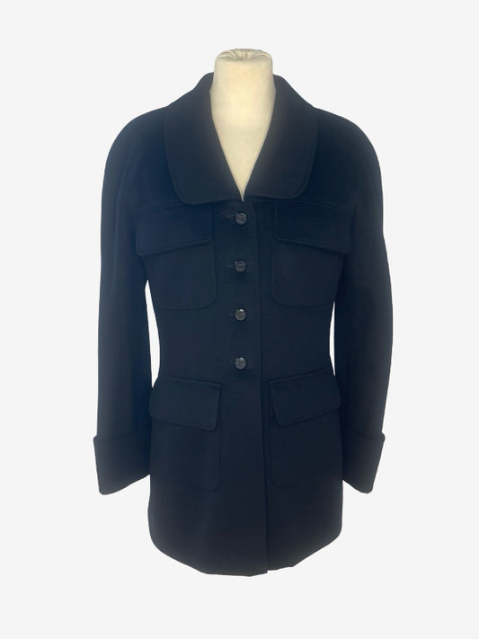 A black wool-blend coat with a wide collar and front button closure, displayed on a cream mannequin torso against a light gray background.