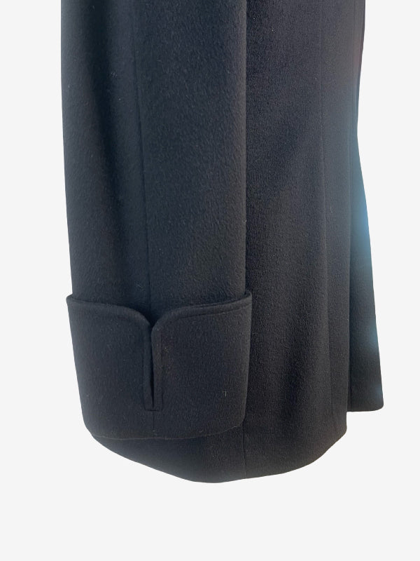 Close-up of a black cashmere jacket sleeve with a buttoned cuff detail, shown against a plain white background.
