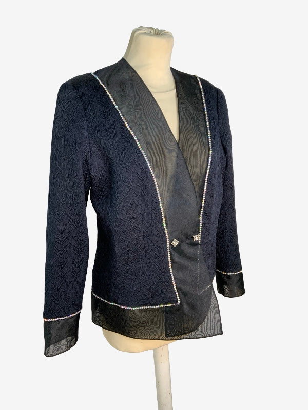 A black  textured blazer with black mesh trim and silver rhinestone piping, displayed on a beige mannequin torso against a light gray background.