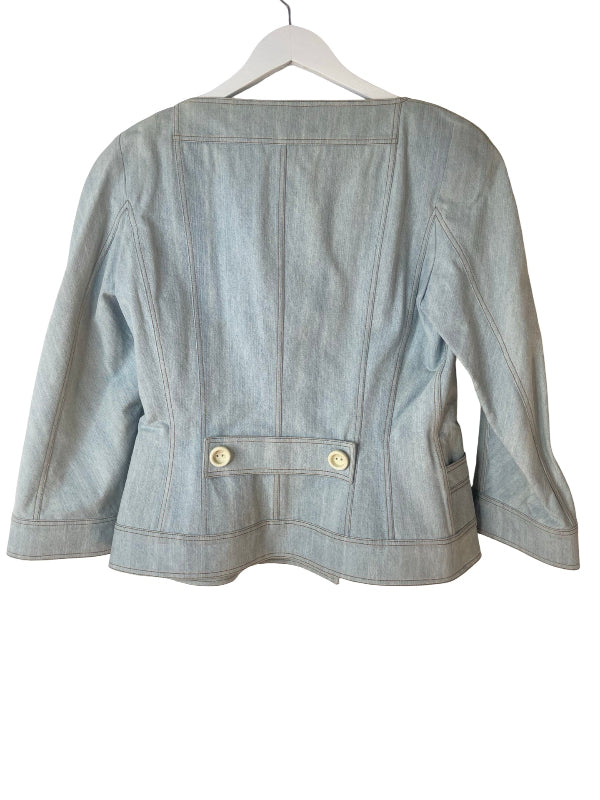 A light blue denim jacket shown from the back, hanging on a white hanger against a plain white background.