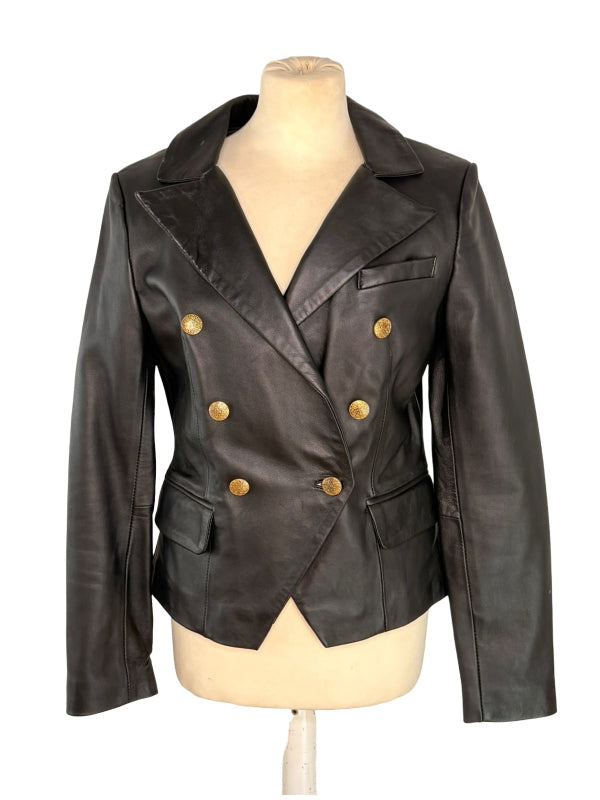 A black leather double-breasted blazer jacket with gold buttons, displayed on a beige mannequin torso against a white background.