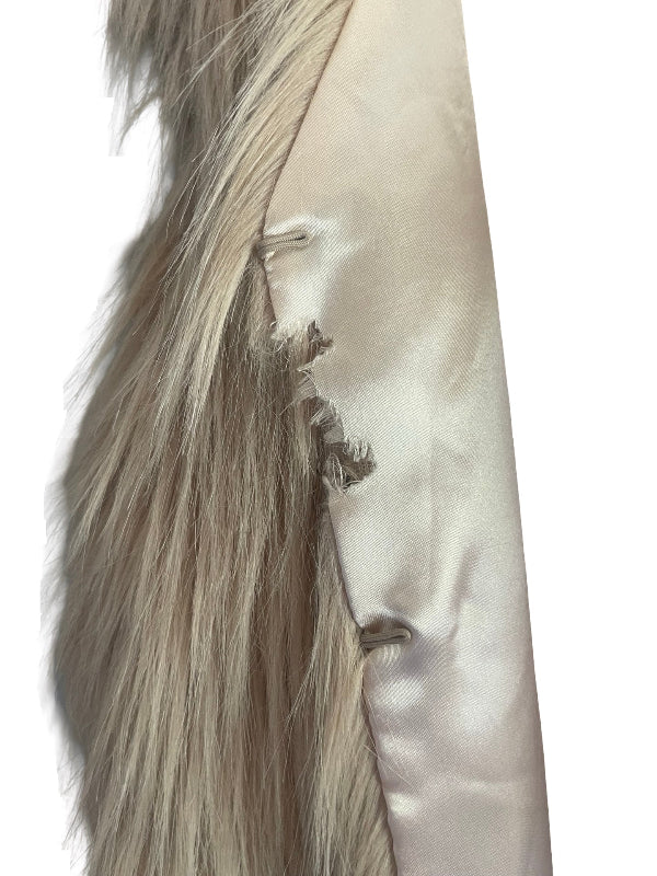 Close-up detail of a faux fur vest with a light beige satin lining, showing the texture of the fur and the satin fabric against a white background.