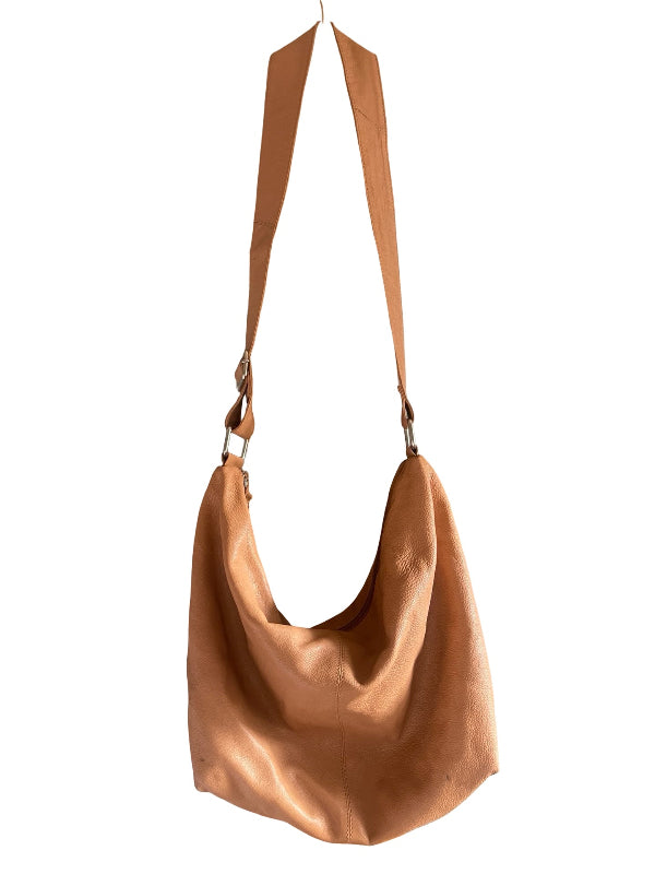 A slouchy hobo shoulder bag in smooth tan leather with a matching adjustable shoulder strap, shown against a plain white background.