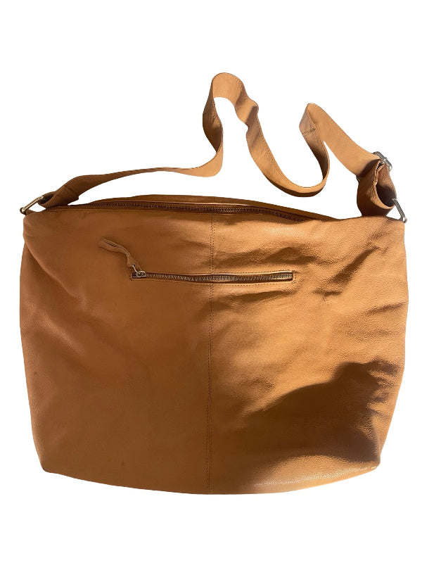 A tan leather shoulder bag with a wide top opening, a long adjustable strap, and a horizontal zippered pocket on the front, shown against a plain white background.